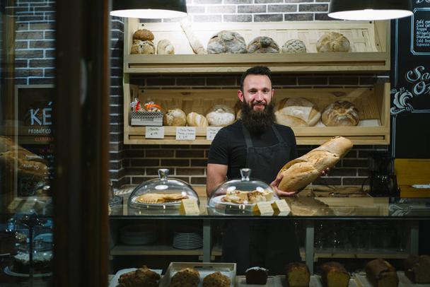 man hipster works in the bakery